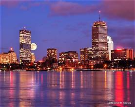 Boston skyline illuminated at night across the Charles River